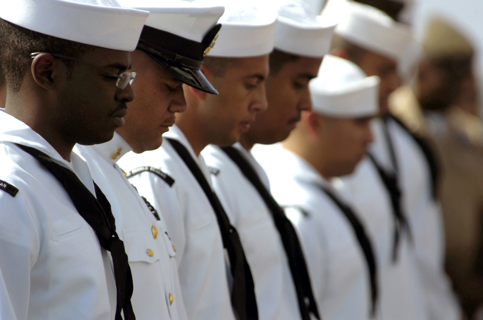 us navy sailors bow their heads for a brief moment at the commencement of a fe80d1 1600