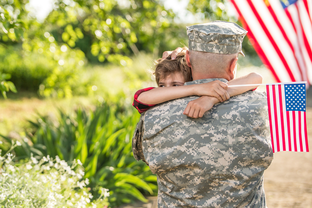 Vet holds child after finishing his treatment at a veteran rehab center in Morriston Florida