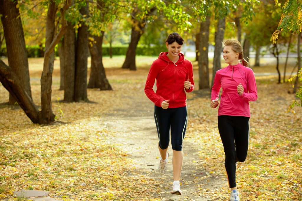 two women jogging in the woods after completing our primary mental health therapy program in Morriston