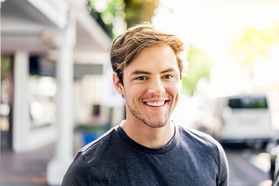 A young man smiling after completing mental health counseling for substance use disorders at Transformations at Mending Fences in beautiful northern Florida, a leading treatment center for co-occurring disorders