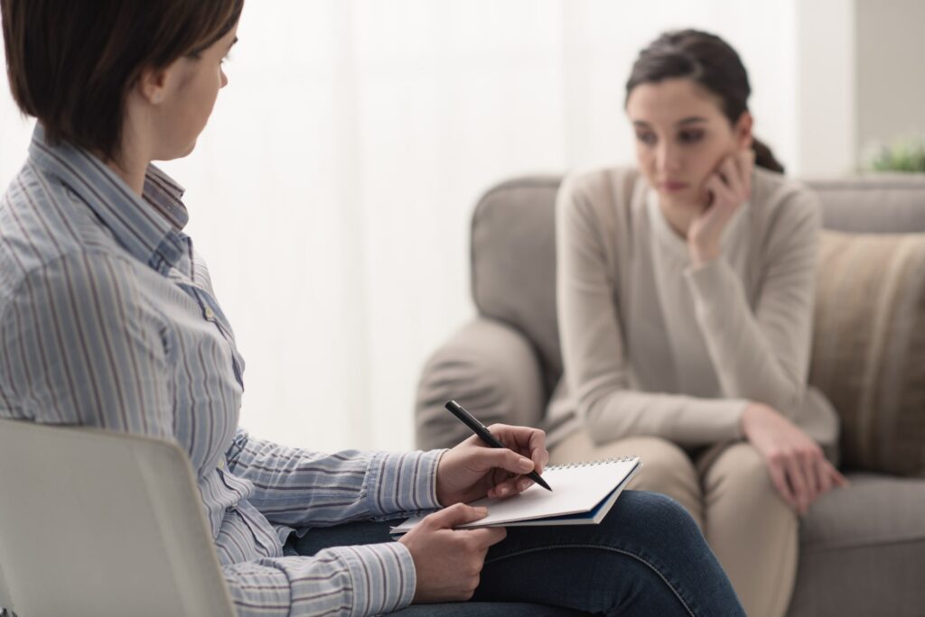 a young woman with social anxiety disorder in therapy talking to a mental health professional at Transformations Mending Fences about her sleep problems, rapid heartbeat, panic attacks, and constant worry