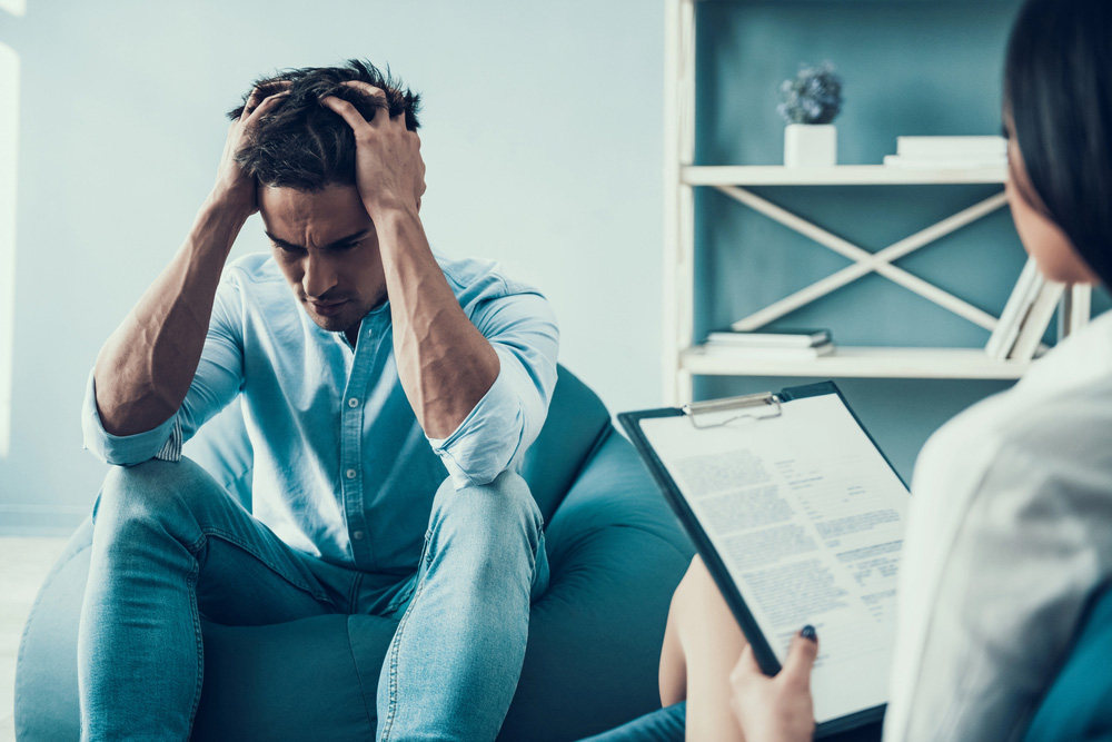 Depressed man consults psychologist, learning the benefits of residential mental health treatment